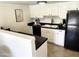 Functional kitchen with white cabinets, black appliances, and ample counter space at 3511 E Baseline Rd # 1214, Phoenix, AZ 85042