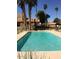 Community pool featuring clear water, lounge seating, and tall palm trees at 3511 E Baseline Rd # 1214, Phoenix, AZ 85042