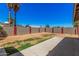 Large fenced backyard with a concrete patio, great for entertaining and outdoor enjoyment at 3540 E Dolphin Ave, Mesa, AZ 85204