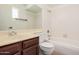 Bathroom featuring a vanity, mirror, toilet, and a bathtub with white tiles at 3540 E Dolphin Ave, Mesa, AZ 85204