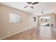 Bright bedroom with tile floors, neutral paint, ceiling fan, and windows, creating a comfortable and versatile space at 3540 E Dolphin Ave, Mesa, AZ 85204