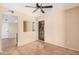 Versatile room with tile flooring, neutral walls, ceiling fan, and a private exterior door with security, suitable for a bedroom at 3540 E Dolphin Ave, Mesa, AZ 85204