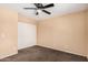 Bedroom with a ceiling fan and a double door closet, perfect for storage at 3540 E Dolphin Ave, Mesa, AZ 85204