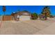 Home exterior featuring a two-car garage and low-maintenance desert landscaping in front at 3540 E Dolphin Ave, Mesa, AZ 85204