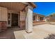 Inviting front porch with brick accents, decorative security door, and textured stucco, offering a welcoming entrance to the home at 3540 E Dolphin Ave, Mesa, AZ 85204