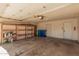 Spacious garage featuring ample storage with installed shelving and dual waste receptacles at 3540 E Dolphin Ave, Mesa, AZ 85204