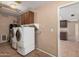 Bright laundry room with a washer, dryer, and wall cabinets at 3540 E Dolphin Ave, Mesa, AZ 85204