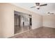 Open-concept living space with tile flooring, neutral walls, and ceiling fans, seamlessly connecting multiple living areas at 3540 E Dolphin Ave, Mesa, AZ 85204