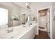 Bright bathroom with dual sinks, large mirror, neutral color palette, and separate shower at 35707 N 34Th Ln, Phoenix, AZ 85086
