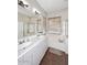 Spacious bathroom with double sinks, a large mirror, and a separate bathtub and shower area at 35707 N 34Th Ln, Phoenix, AZ 85086