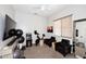 Comfortable exercise room features ceiling fan, large mirror, and additional sitting area at 35707 N 34Th Ln, Phoenix, AZ 85086