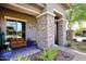 Close-up of a charming front porch with textured stone pillars and desert-style greenery at 35707 N 34Th Ln, Phoenix, AZ 85086