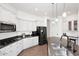 Spacious kitchen boasts stainless steel appliances, granite counters, and bright white cabinetry at 35707 N 34Th Ln, Phoenix, AZ 85086