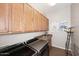 Functional laundry room includes front-load machines, ample cabinet storage, and utility sink at 35707 N 34Th Ln, Phoenix, AZ 85086