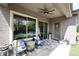 Covered patio with stone flooring, ceiling fan, and comfortable seating at 35707 N 34Th Ln, Phoenix, AZ 85086