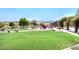 Community playground with slides, swings, and climbing structures surrounded by lush green grass at 35707 N 34Th Ln, Phoenix, AZ 85086