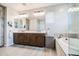 Bathroom featuring double vanity, a soaking tub and a mirror at 3879 E Harrison St, Gilbert, AZ 85295