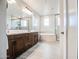 Bathroom featuring a double vanity, soaking tub, and a glass-enclosed shower at 3879 E Harrison St, Gilbert, AZ 85295