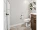 Stylish half bath with wood-look tile flooring, floating shelves, and modern fixtures at 3879 E Harrison St, Gilbert, AZ 85295