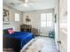This bedroom features unique decor, a ceiling fan, and a comfortable-looking bed at 3879 E Harrison St, Gilbert, AZ 85295