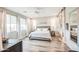 Inviting bedroom showcasing large windows, light hardwood floors and a ceiling fan at 3879 E Harrison St, Gilbert, AZ 85295