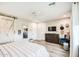 Spacious bedroom with a sliding barn door, a ceiling fan and a light gray accent wall at 3879 E Harrison St, Gilbert, AZ 85295