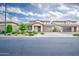 Beautiful front yard with well-maintained landscaping, complemented by a two-car garage and sidewalk at 3879 E Harrison St, Gilbert, AZ 85295