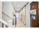 Bright hallway with tiled floors, a staircase, barn door, and entryway view at 3879 E Harrison St, Gilbert, AZ 85295