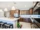 Modern kitchen boasts a large island with seating, stainless appliances, and stylish pendant lighting at 3879 E Harrison St, Gilbert, AZ 85295