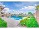 Sparkling pool with deck is surrounded by beautiful greenery for the perfect outdoor retreat at 3879 E Harrison St, Gilbert, AZ 85295