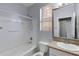 Cozy bathroom with granite countertops, tub with shower, and a framed mirror at 43860 W Roth Rd, Maricopa, AZ 85138