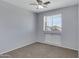 Neutral bedroom with a ceiling fan, carpet, and a window with blinds at 43860 W Roth Rd, Maricopa, AZ 85138