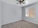 Neutral bedroom featuring carpet, a ceiling fan, and a window providing natural light at 43860 W Roth Rd, Maricopa, AZ 85138