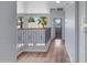 Hallway features wood floors, iron railing, natural light and storage at 43860 W Roth Rd, Maricopa, AZ 85138