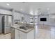Open-concept kitchen featuring stainless steel appliances, granite counters and breakfast bar with pendant lighting at 43860 W Roth Rd, Maricopa, AZ 85138