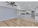 Spacious living area that flows into an eat-in kitchen, featuring white cabinets and modern appliances at 43860 W Roth Rd, Maricopa, AZ 85138