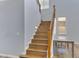 Beautiful wood staircase with custom railing leading to the upper level at 43860 W Roth Rd, Maricopa, AZ 85138
