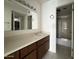Bathroom featuring a vanity with a large mirror, and a shower with glass doors at 4444 E Paradise Village N Pkwy # 251, Phoenix, AZ 85032