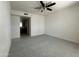 Spacious bedroom with neutral carpet, ceiling fan, and access to ensuite bathroom at 4444 E Paradise Village N Pkwy # 251, Phoenix, AZ 85032