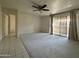 Comfortable living room with plush carpet, ceiling fan, and access to a balcony at 4444 E Paradise Village N Pkwy # 251, Phoenix, AZ 85032