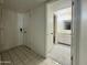 Entryway with tiled floor, closet, and view into bathroom featuring vanity and mirror at 4444 E Paradise Village N Pkwy # 252, Phoenix, AZ 85032