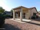 Backyard features a covered patio area, perfect for outdoor dining and relaxation, with low-maintenance landscaping at 4613 E Walnut Rd, Gilbert, AZ 85298