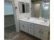 Spacious bathroom features double sinks, white cabinetry, and a separate shower, complemented by a walk-in closet at 4613 E Walnut Rd, Gilbert, AZ 85298