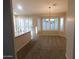 Bright and spacious living room with large windows, plantation shutters and neutral-toned walls at 4613 E Walnut Rd, Gilbert, AZ 85298