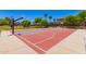 The neighborhood basketball court is surrounded by lush landscaping and palm trees at 4752 E Portola Valley Dr # 103, Gilbert, AZ 85297
