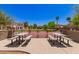 Enjoy a game of basketball on the community court with picnic tables and residential buildings at 4752 E Portola Valley Dr # 103, Gilbert, AZ 85297