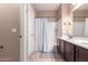 A bathroom with a double sink vanity, dark cabinets, and a shower-tub combination at 4752 E Portola Valley Dr # 103, Gilbert, AZ 85297
