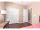 Bedroom showcasing wood flooring, closet, desk, and private entry to the ensuite bath at 4752 E Portola Valley Dr # 103, Gilbert, AZ 85297