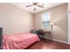 Bedroom with wood floors, desk, ceiling fan, and a window bringing in natural light at 4752 E Portola Valley Dr # 103, Gilbert, AZ 85297