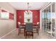 Cozy dining area with a wooden table, four chairs, and sliding glass doors at 4752 E Portola Valley Dr # 103, Gilbert, AZ 85297